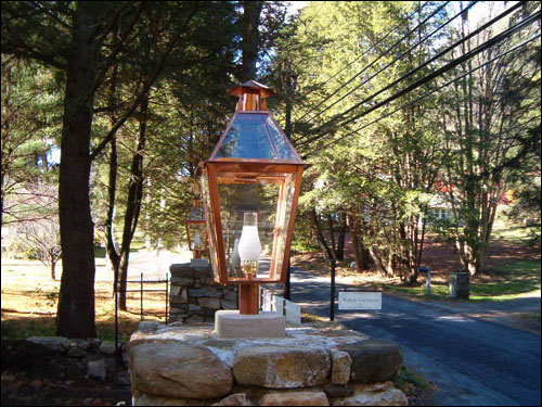 Copper lamps installed at driveway entrance